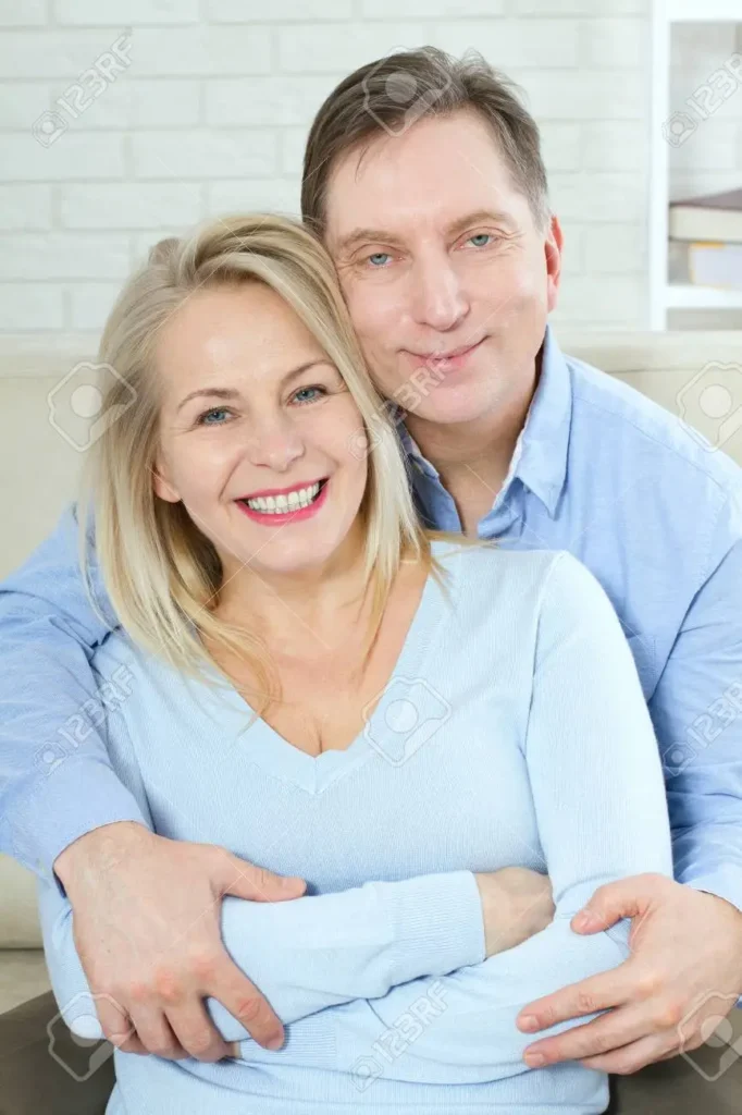 Portrait of a happy smiling blonde mature woman and her husband, illustrating restored vitality and relationship confidence.