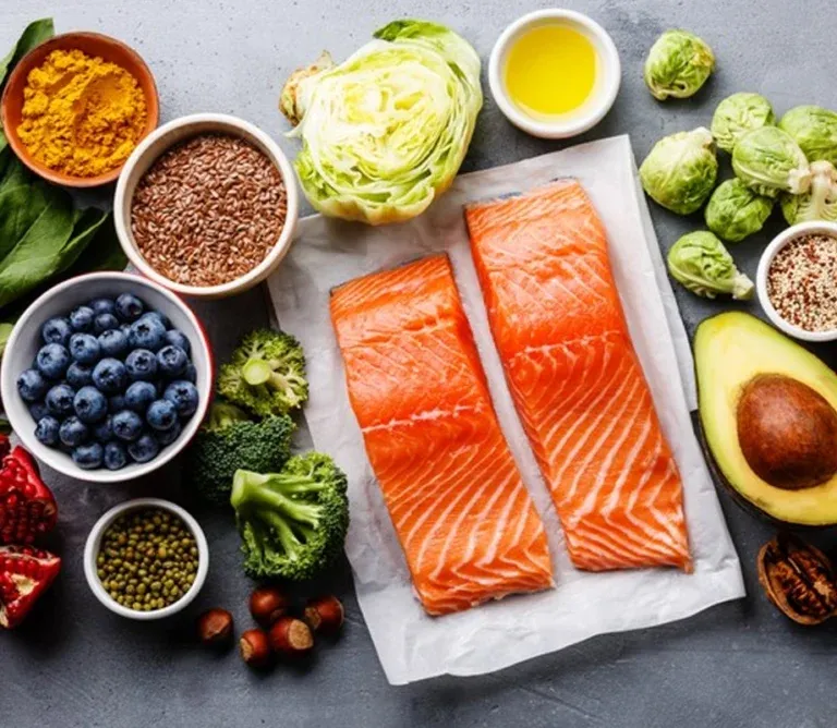 Fresh salmon fillets, avocado, nuts, and green vegetables arranged on a table, illustrating a diet rich in healthy fats and nerve vitamins.